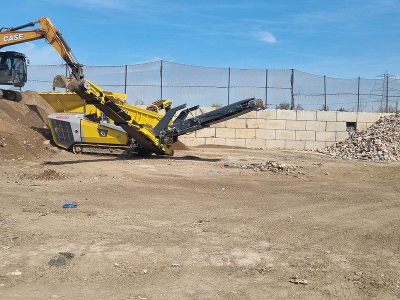 Mobile screening plant and excavator processing soils and aggregates